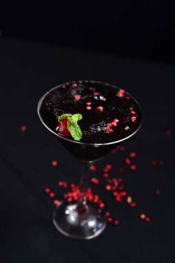 gin and tonic alcoholic iced drink vodka soda berries negrone juice with cinnamon isolated on black background