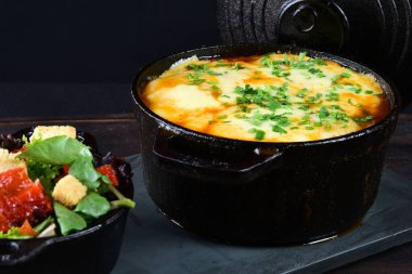 rice with meat sausage bacon and melted cheese served with salad and bread toast