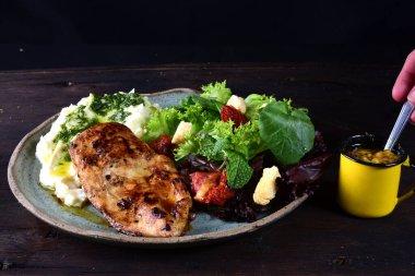 fried fish fillet with boiled mashed potatoes and salads
