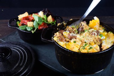 rice with meat sausage bacon and melted cheese served with salad and bread toast