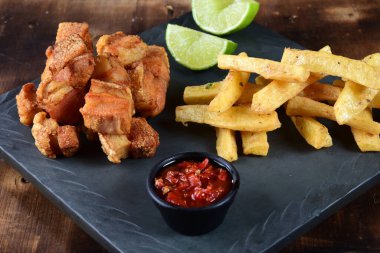 panceta fried pork skin crackling crackling with fries, typical Brazilian food