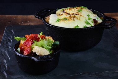 rice with meat sausage bacon and melted cheese served with salad and bread toast