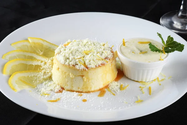 Delicious condensed milk and coconut pudding on a white plate - Coconut pudding with eggs sprinkled with powdered milk