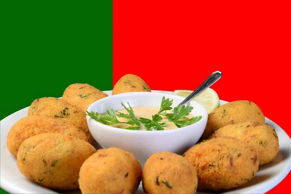 codfish cake typical portuguese food fish croquette with herbs sauce on colorful background in colors of portugal flag