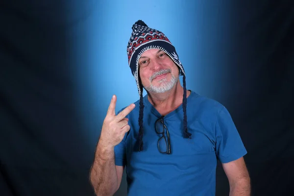 stock image happy bald man with white beard Peruvian cap on his head looking forward with good expression