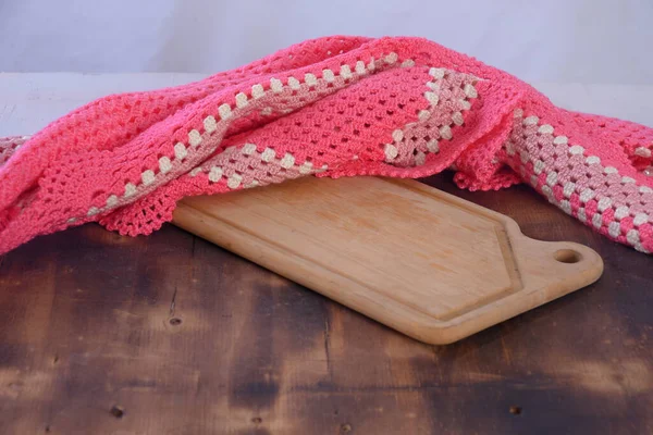 food serving board with pink tablecloth in the background image