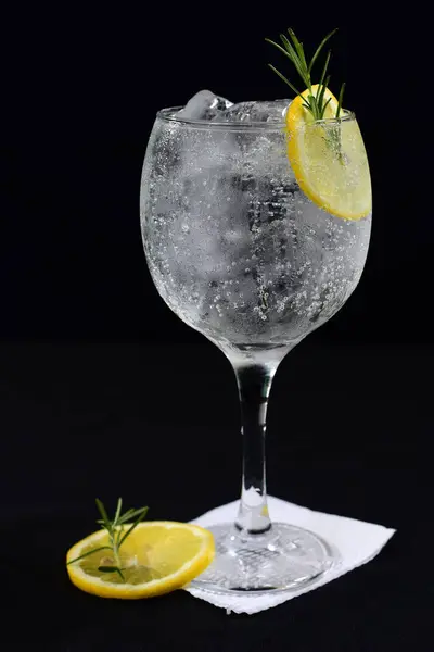 refreshing alcoholic drink with fruits, chilled vodka and gin, lemon peel served in glass tumbler