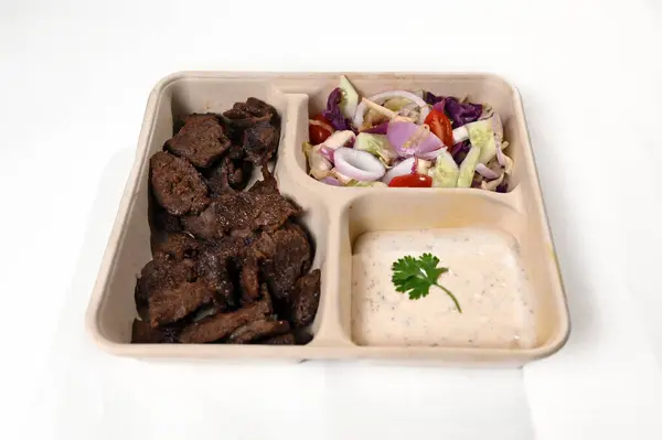 biodegradable lunch tray with roast meat salad herb sauce healthy food protein taste