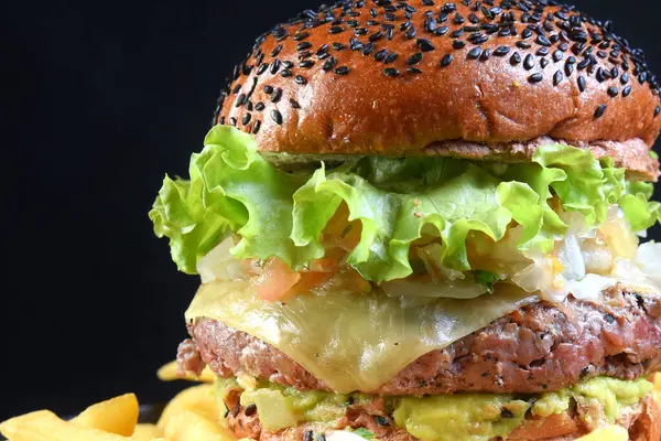 hamburger sandwich with melted cheese lettuce tomato mayonnaise and bread delicious fast food traditional snack taste