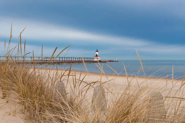 stock image View of the Michigan City lighthouse from Washington Park Beach on a stormy Spring morning.  Michigan City, Indiana, USA.