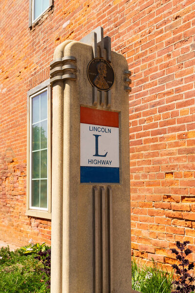 DeKalb, Illinois - United States - August 15th, 2023: Lincoln Highway marker on a beautiful Summer morning in downtown Dekalb, Illinois, USA.
