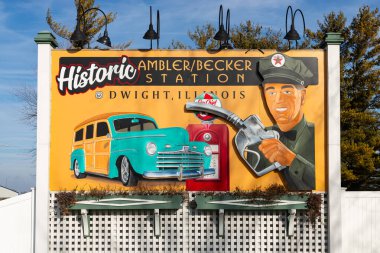 Dwight, Illinois - United States - January 2nd, 2024: Roadside attraction billboard for the historic Ambler and Becker Station on historic Route 66 in Dwight, Illinois, USA. clipart