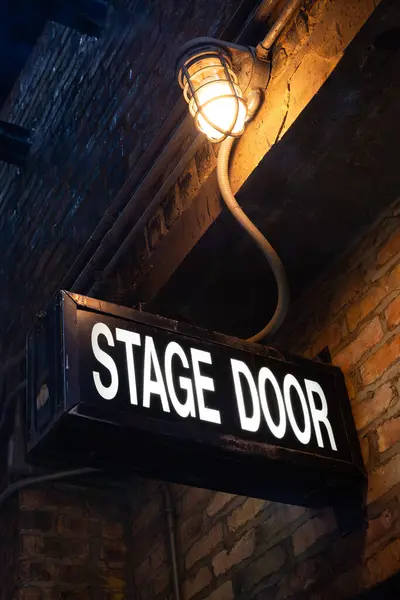 Stage door sign in downtown Chicago alley.