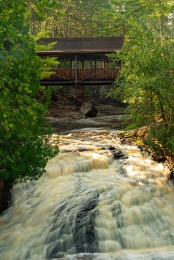 Flowing Lower Falls waterfall on a beautiful Summer morning at Amnicon State Park in Wisconsin, USA. clipart