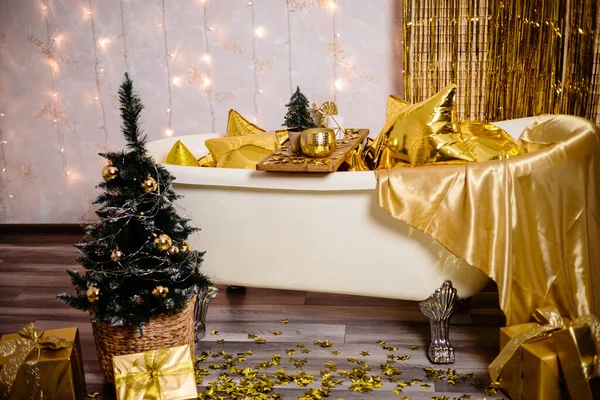 New Year\'s decoration of the room in golden color. The concept of the holiday and festive design. Home decor for the New Year.