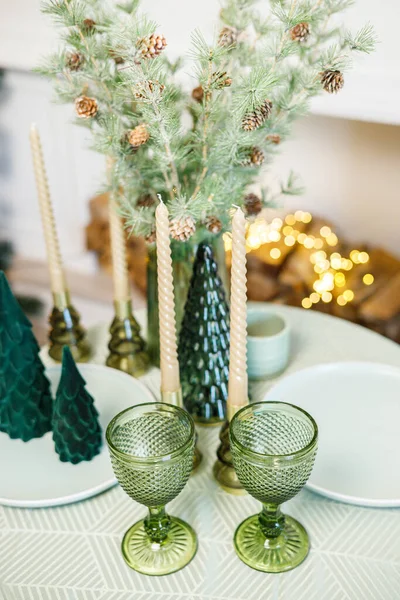 stock image The table is set near the Christmas tree for a romantic New Year's dinner. New Year's festive dinner.