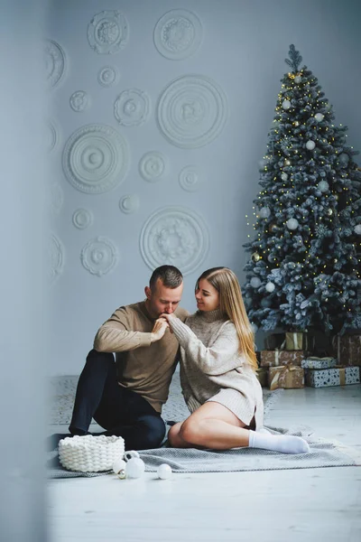 A beautiful couple embraces during a New Year's photo session. Lovers welcome the new year together. A couple in love enjoying each other on New Year's Eve. New Year and Christmas. February 14th.