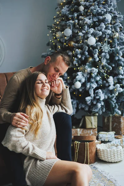 A beautiful couple embraces during a New Year\'s photo session. Lovers welcome the new year together. A couple in love enjoying each other on New Year\'s Eve. New Year and Christmas. February 14th.
