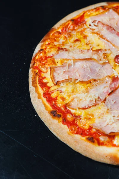 stock image Delicious freshly baked pizza with tomato sauce and meat and cheese filling.