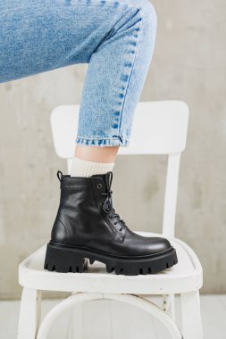Kotlu kadın bacakları ve siyah deri çizmeleri. Kadın kış ayakkabıları.