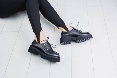 Beyaz arka planda siyah deri çizmeli güzel kadın bacakları. Boşluğu kopyala