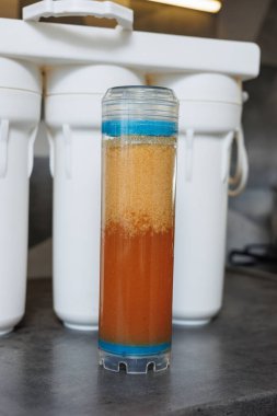 Replaceable cartridges in the water filter system. Water filtration system with replaceable cartridges. A system in the apartment with three tanks for cleaning tap water.