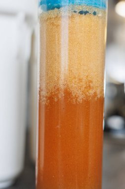 Replaceable cartridges in the water filter system. Water filtration system with replaceable cartridges. A system in the apartment with three tanks for cleaning tap water.