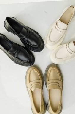 Women's leather stylish loafers on a white background, women's summer shoes close-up. Fashionable shoes for women. Selective focus