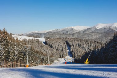 Winter landscape of snowy mountains with winter forest. Winter landscape