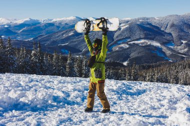 Winter sport. A snowboarder walks down a snowy slope in winter on the snow. Snowboarding, winter freeride