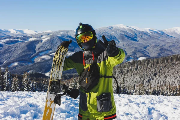 Winter sport. A snowboarder walks down a snowy slope in winter on the snow. Snowboarding, winter freeride