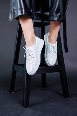 Female legs in leather pants and black leather boots. Women's casual leather spring boots. Stylish shoes for women