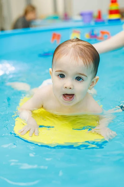 stock image Little boy 2 years old are in the pool. Swimming lessons for young children.