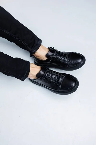 Närbild Manliga Ben Svarta Jeans Och Svart Läder Casual Sneakers — Stockfoto
