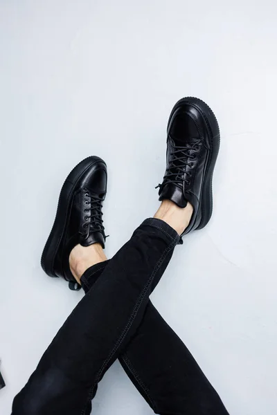 stock image Close up of male legs in black jeans and black leather casual sneakers. Comfortable men's demi-season shoes