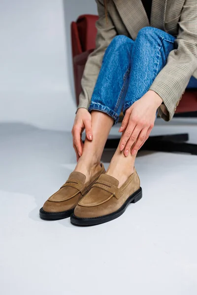 Casual women\'s fashion. Classic shoes for women. Slender female legs in trousers and brown stylish casual loafers. Women\'s comfortable summer shoes.