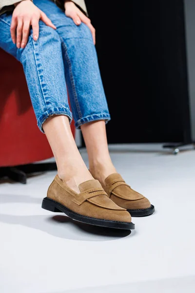 Casual women\'s fashion. Classic shoes for women. Slender female legs in trousers and brown stylish casual loafers. Women\'s comfortable summer shoes.