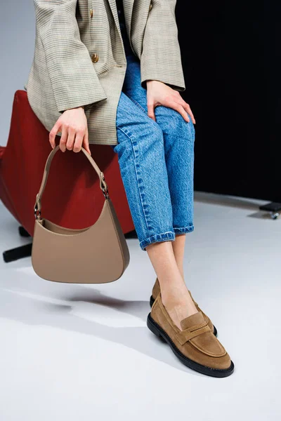 Casual women\'s fashion. Classic shoes for women. Slender female legs in trousers and brown stylish casual loafers. Women\'s comfortable summer shoes.