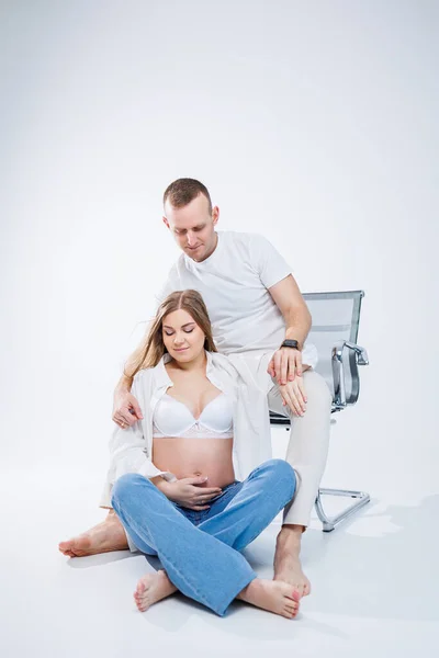 Happy Young Couple Expecting Baby White Shirts Jeans White Background — Stock Photo, Image