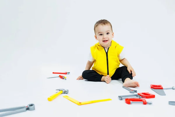 stock image A 2-year-old boy plays with plastic construction tools. Children's plastic toys. Children's builder's set.