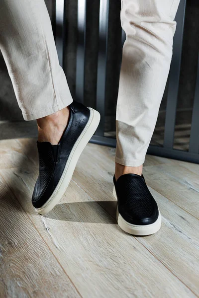 stock image Male legs in leather shoes. Comfortable men's black shoes without laces. Casual men's moccasins