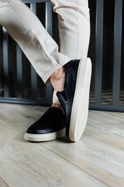 stock image Male legs in leather shoes. Comfortable men's black shoes without laces. Casual men's moccasins