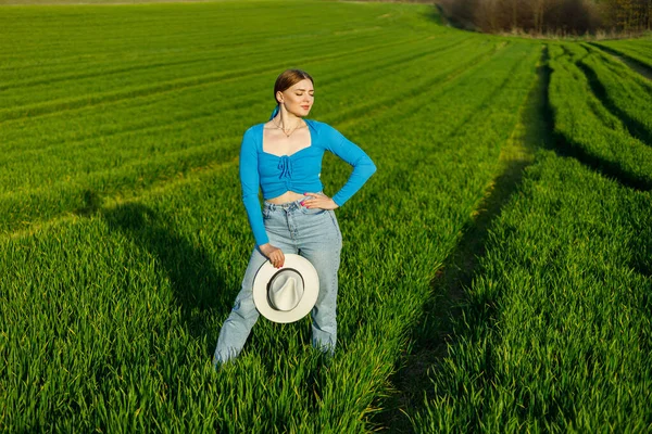 Cute Woman Jeans Hat Stands Green Field Smiling Woman Blue — Stock Photo, Image