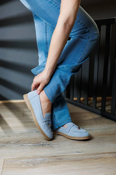 stock image Slender female legs in jeans and blue loafers. Collection of summer women's shoes. Stylish women's shoes for summer