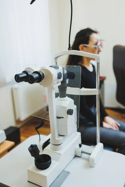 Examination of vision on modern ophthalmological equipment. Eye examination of a woman at an ophthalmologist\'s appointment using microscopes. Vision treatment at an ophthalmologist appointment