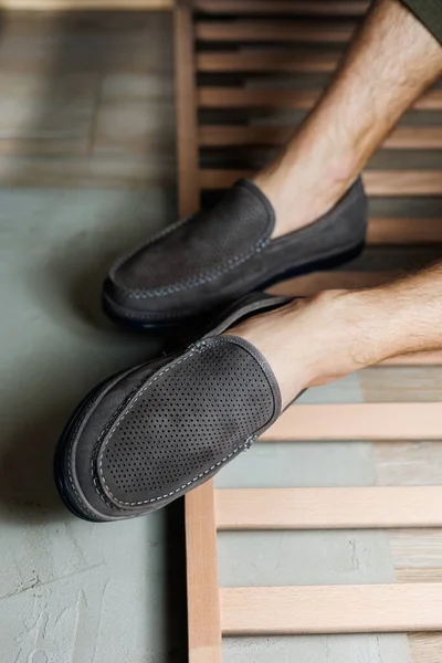 stock image Male legs close-up in jeans and beige genuine leather moccasins.