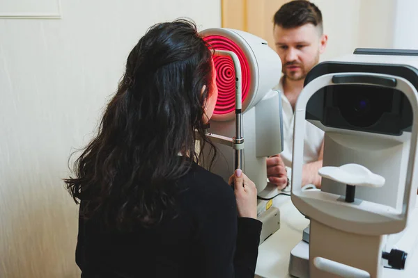 stock image Examination of vision on modern ophthalmological equipment. Eye examination of a woman at an ophthalmologist's appointment using microscopes. Vision treatment at an ophthalmologist appointment