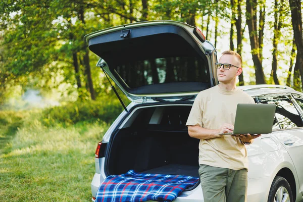 Cheerful Traveler Young Man Sitting Open Trunk Car Working Laptop Royalty Free Stock Photos