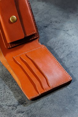 El yapımı hakiki deri ürünler. Erkek ve kadın cüzdanı. Gri bir arka planda yatıyor. Nesnenin üst görünümü.