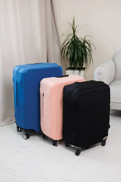 Cover for a suitcase with wheels. Suitcase for things in a cover against damage. A suitcase for a tourist